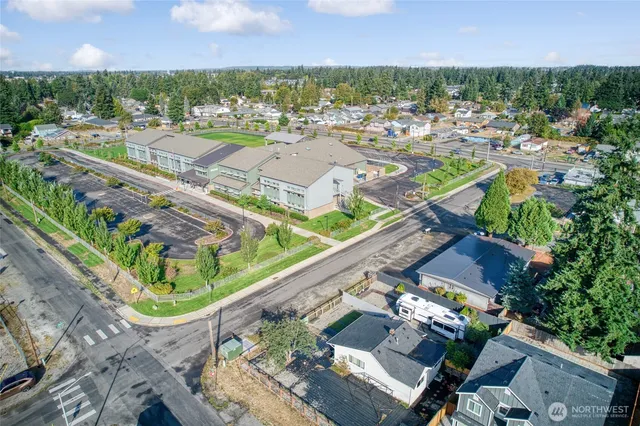 an aerial view of a city with lots of residential buildings and mountain view in back