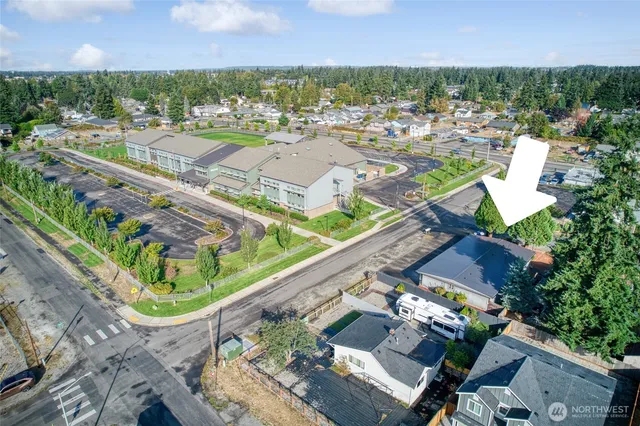 an aerial view of a city with lots of residential buildings and mountain view in back