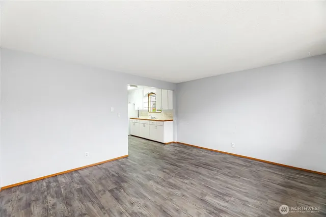 a view of a kitchen with wooden floor and a sink