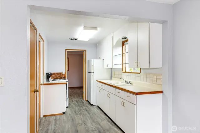 a kitchen with a sink stove and cabinets