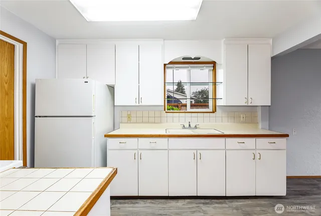 a kitchen with stainless steel appliances granite countertop a refrigerator sink and cabinets