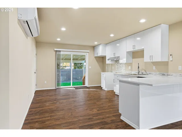 a kitchen with stainless steel appliances granite countertop a sink and a stove