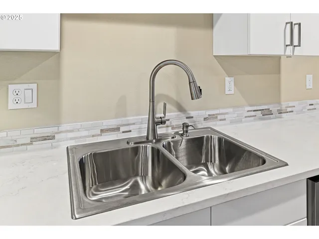 a close view of a sink and stove in a kitchen