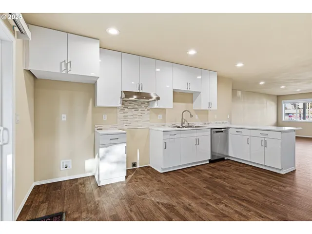 a kitchen with white cabinets and white appliances