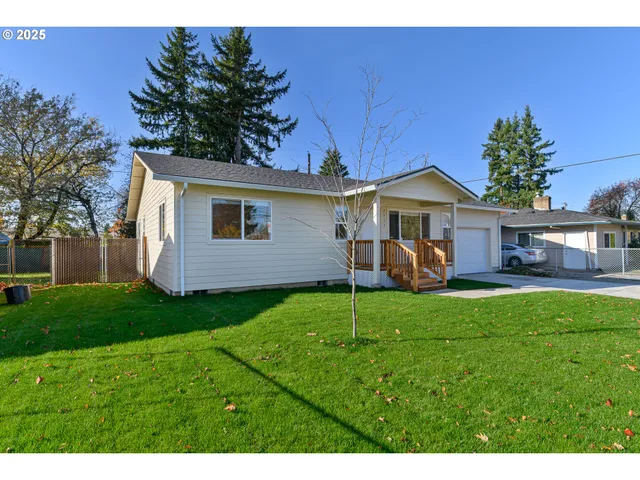 a view of a house with a backyard