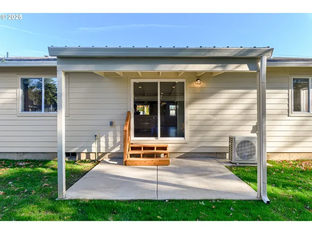 an aerial view of a house with garden space and street view