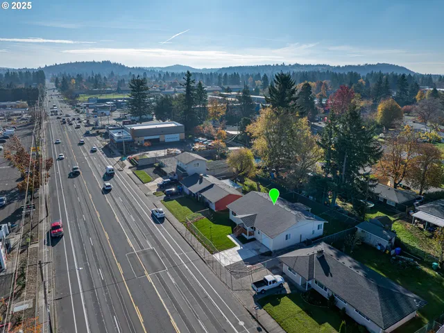 an aerial view of a house with garden space and street view