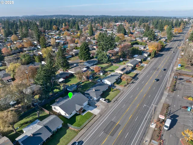 an aerial view of a house with a garden and a yard