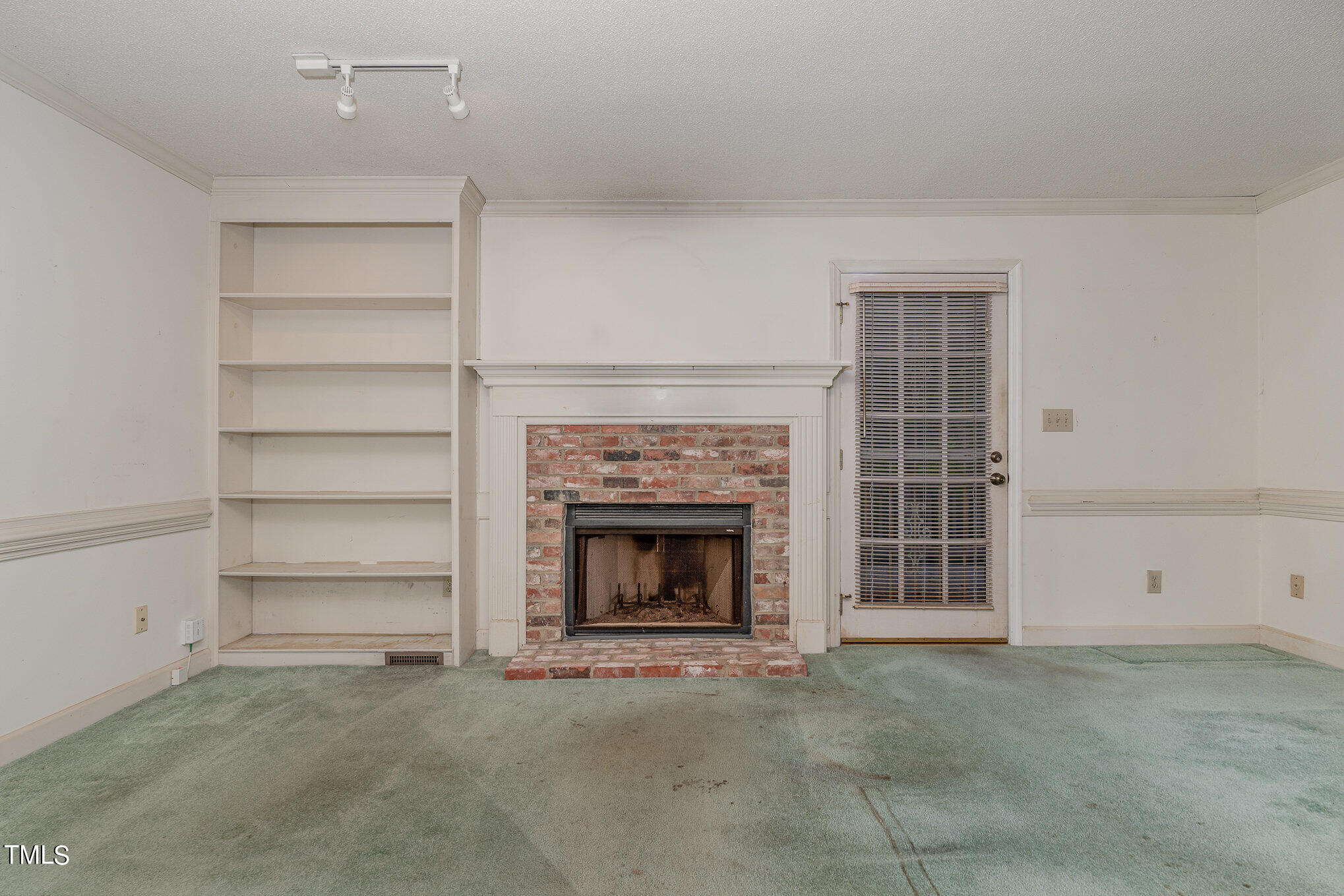 6700 Queen Annes Drive Raleigh, NC 27613 - Photo 5 of 28 a living room with furniture and a fireplace