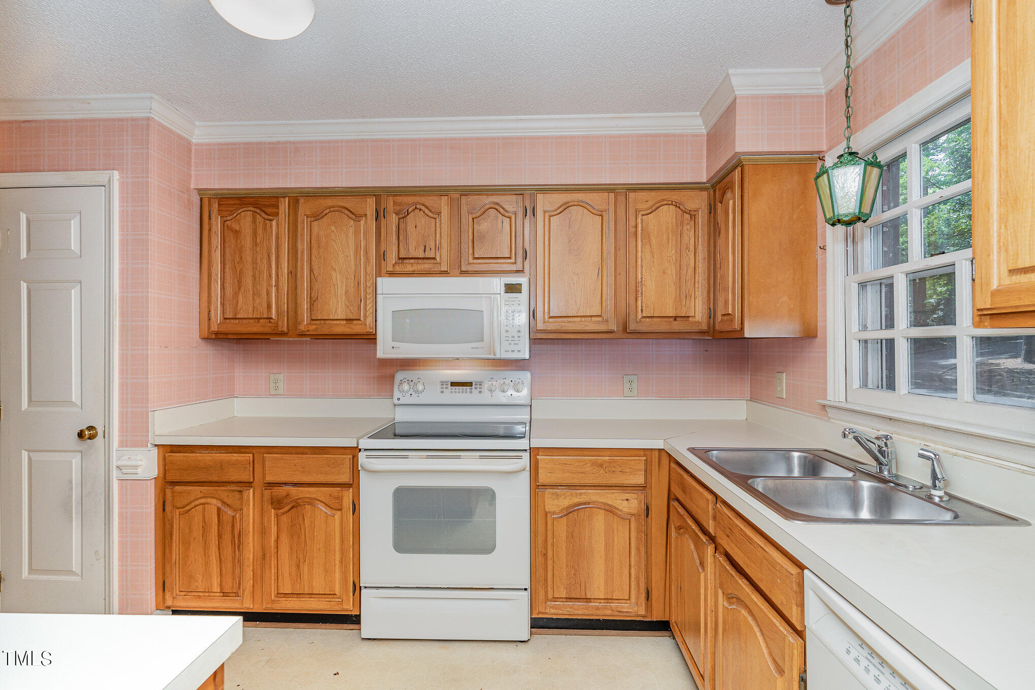 6700 Queen Annes Drive Raleigh, NC 27613 - Photo 8 of 28 a kitchen with a sink stove and cabinets