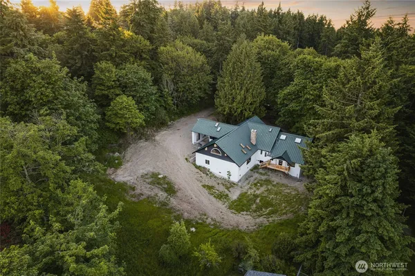 an aerial view of a house with a yard