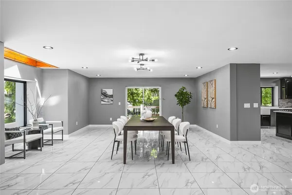 a view of a dining room with furniture and a chandelier
