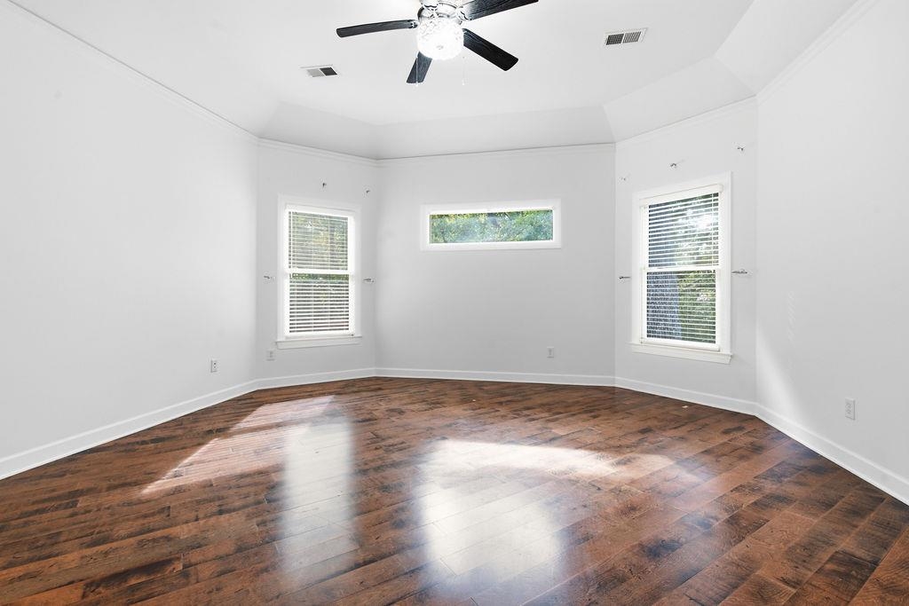 285 Great Falls Road Collierville, TN 38017 - Photo 10 of 29 Tray ceiling with crown molding, wood-finish flooring, and multiple windows