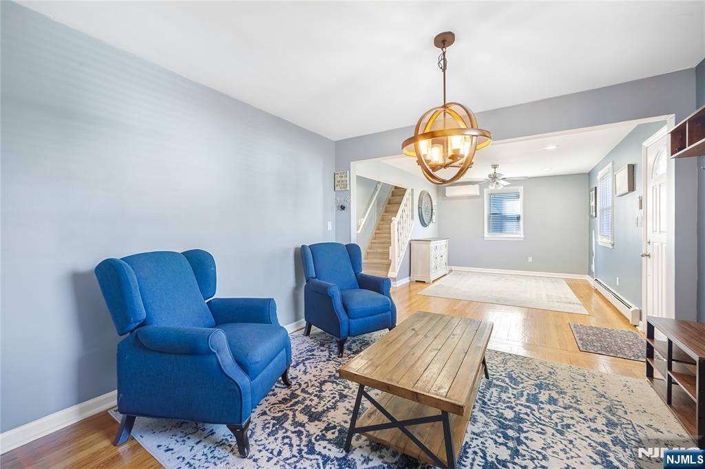 23-26 Berkshire Road Fair Lawn, NJ 07410 - Photo 11 of 36 a living room with furniture a rug and a clock