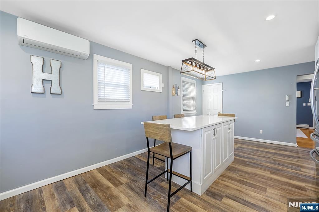 23-26 Berkshire Road Fair Lawn, NJ 07410 - Photo 16 of 36 a kitchen that has a sink a window and chairs in it