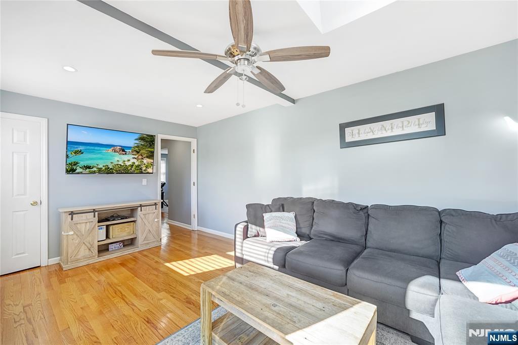 23-26 Berkshire Road Fair Lawn, NJ 07410 - Photo 19 of 36 a living room with furniture and a flat screen tv
