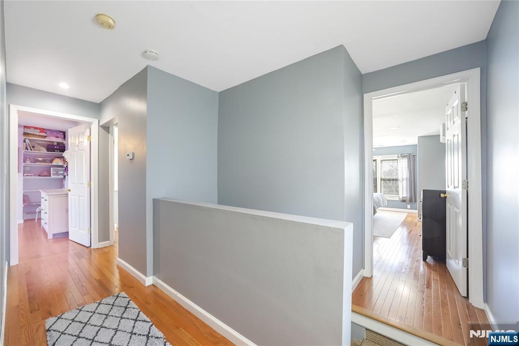 23-26 Berkshire Road Fair Lawn, NJ 07410 - Photo 20 of 36 a view of a hallway with wooden floor and cabinet