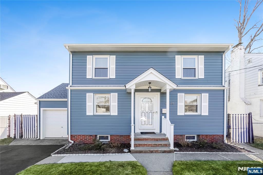 23-26 Berkshire Road Fair Lawn, NJ 07410 - Photo 2 of 36 a front view of a house with a yard