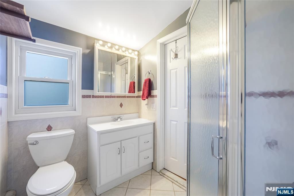 23-26 Berkshire Road Fair Lawn, NJ 07410 - Photo 24 of 36 a bathroom with a toilet sink and mirror