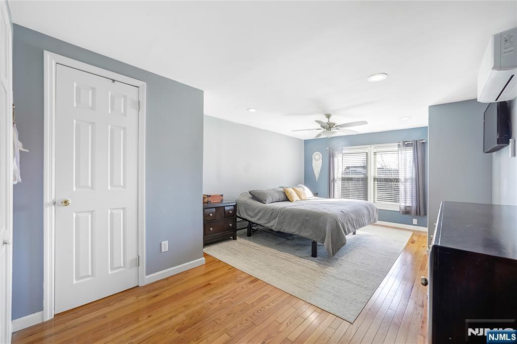 23-26 Berkshire Road Fair Lawn, NJ 07410 - Photo 25 of 36 a spacious bedroom with a bed and wooden floor