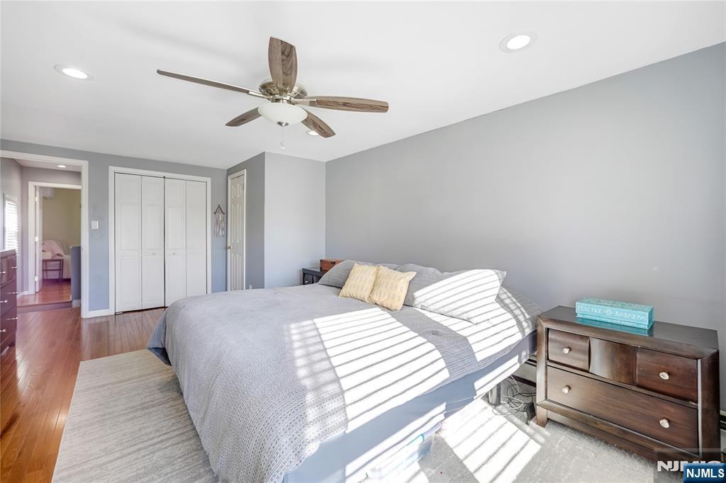 23-26 Berkshire Road Fair Lawn, NJ 07410 - Photo 26 of 36 a bedroom with a bed and a chandelier