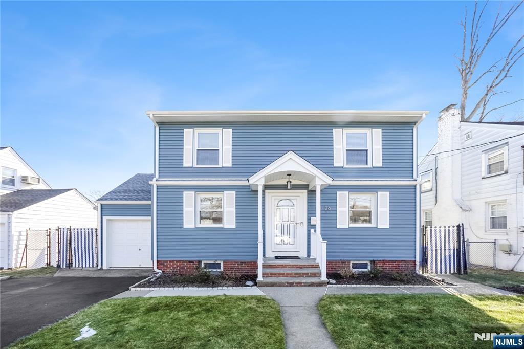23-26 Berkshire Road Fair Lawn, NJ 07410 - Photo 3 of 36 a front view of a house with a yard