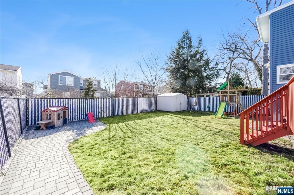 23-26 Berkshire Road Fair Lawn, NJ 07410 - Photo 32 of 36 a view of a backyard with a wooden fence