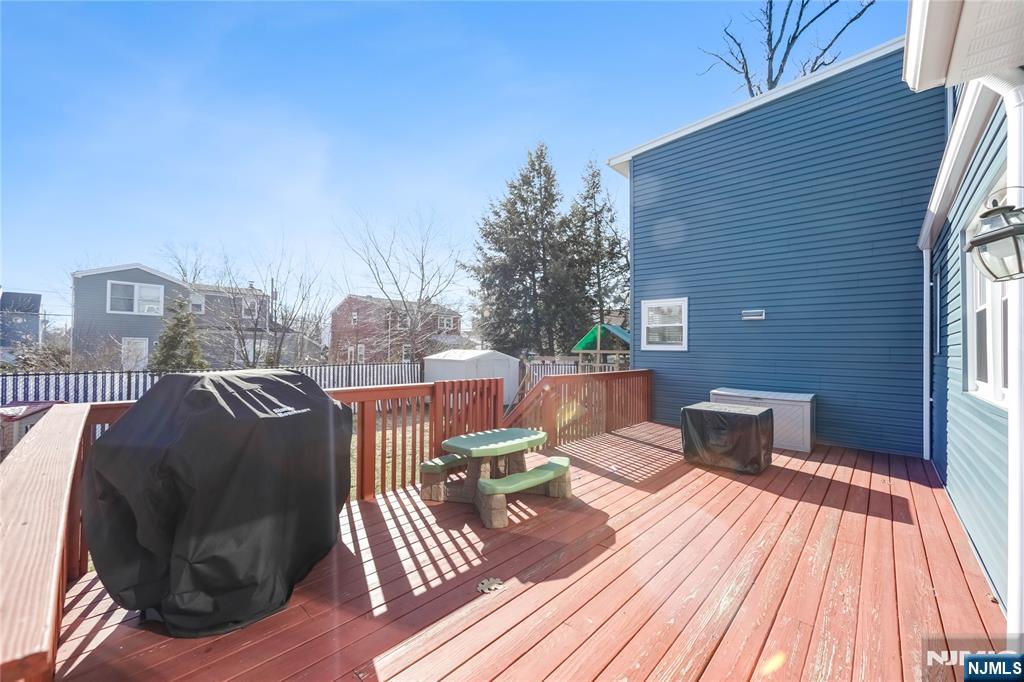 23-26 Berkshire Road Fair Lawn, NJ 07410 - Photo 34 of 36 a view of a roof deck with wooden floor and city view