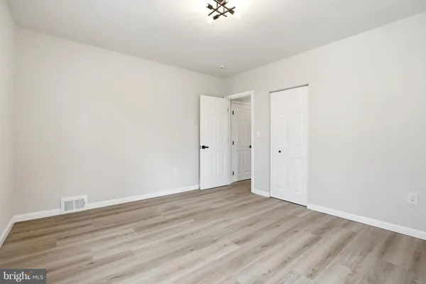 a view of room with wooden floor