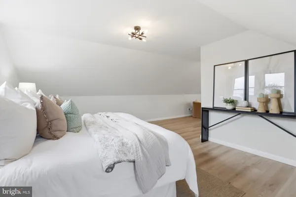 a bedroom with a bed and a large mirror