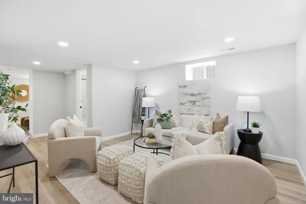 a living room with furniture and a lamp