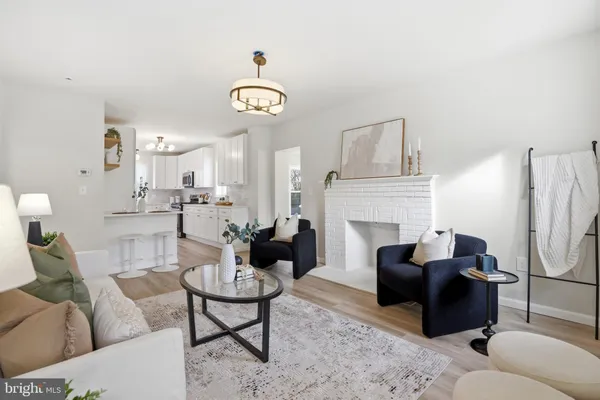 a living room with furniture a fireplace and a clock