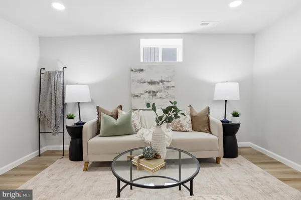 a living room with furniture and a lamp