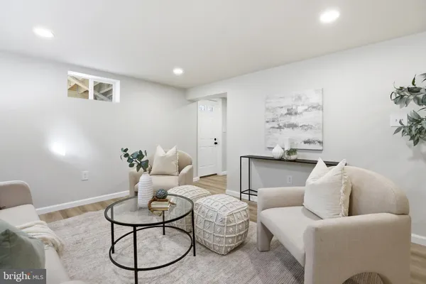 a living room with furniture flowerpot and window