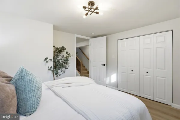 a spacious bedroom with a bed and a chandelier