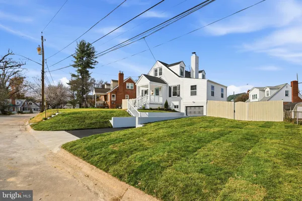 a view of a house with many windows and a yard