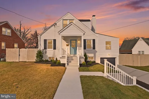 a view of a house with wooden floor next to a yard