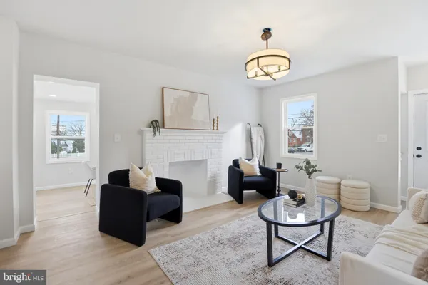 a living room with furniture a fireplace and a table