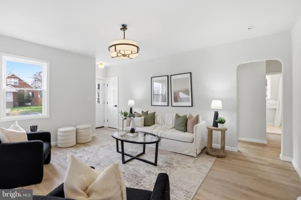a living room with furniture a table and a clock