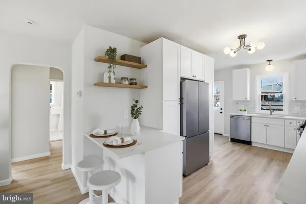 a kitchen with stainless steel appliances granite countertop a refrigerator and microwave