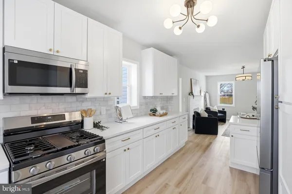 a kitchen with stainless steel appliances a stove microwave and cabinets