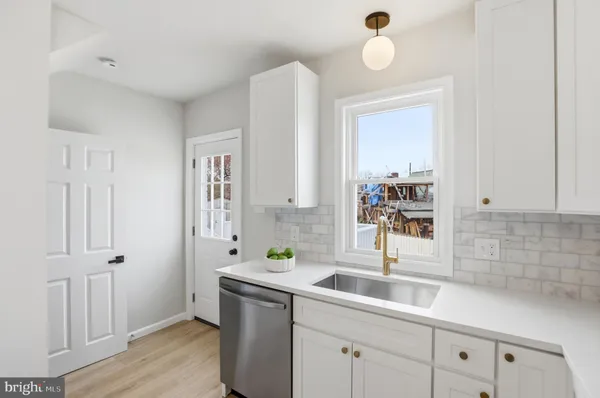 a kitchen with a sink and cabinets