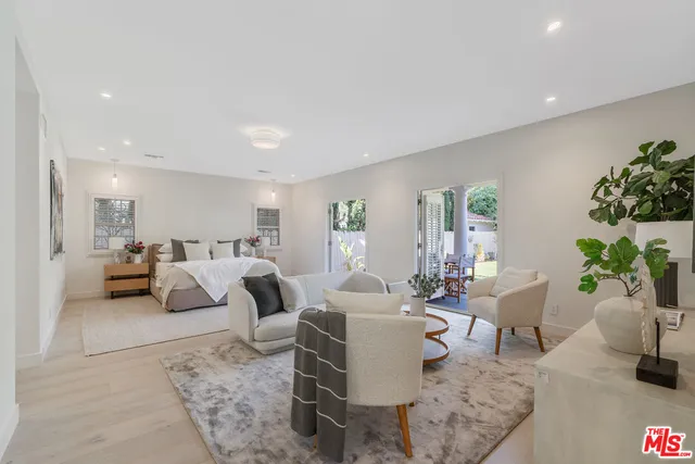 a living room with furniture and flowers