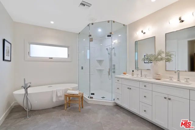 a bathroom with a double vanity sink tub and shower