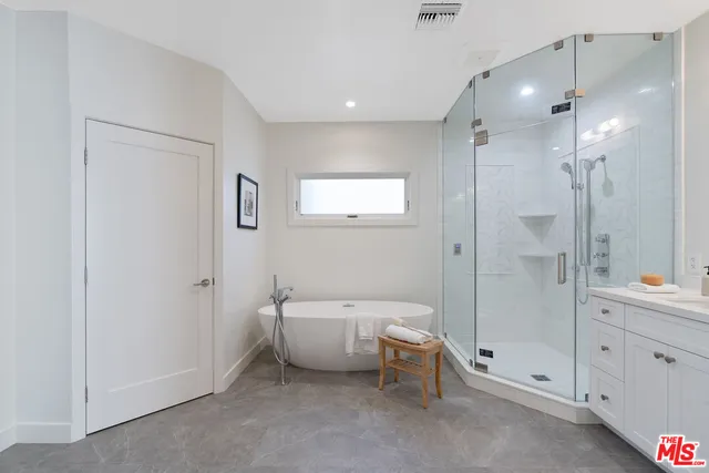 a bathroom with a bathtub and a shower