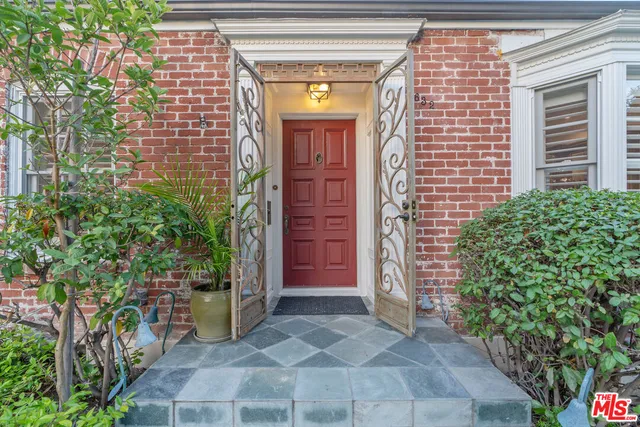 a view of entrance of the house and potted plants