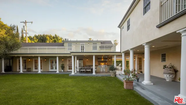 a front view of a house with a yard table and chairs