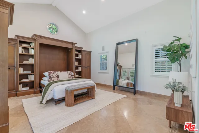 a bedroom with a bed and a potted plant