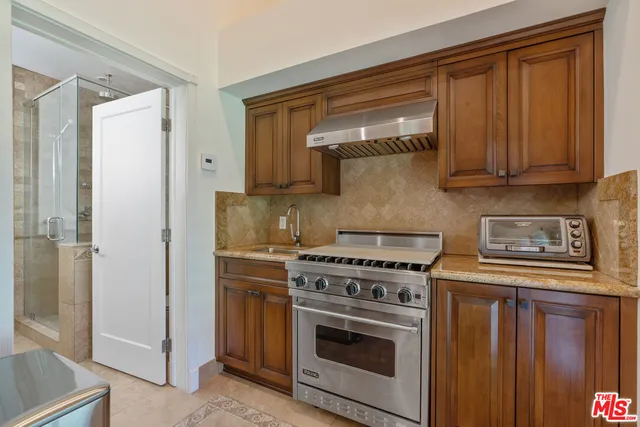 a kitchen with stainless steel appliances granite countertop a stove and a refrigerator