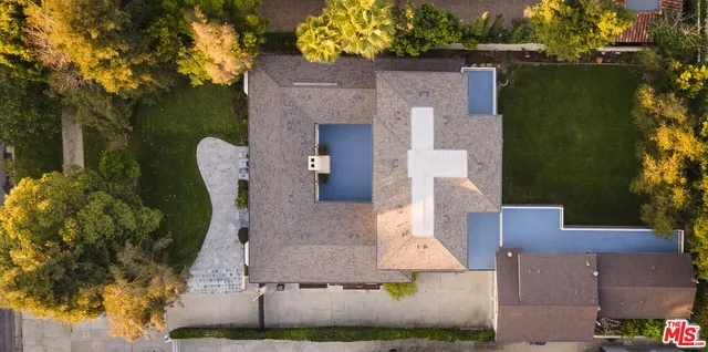 an aerial view of a house with a garden and pool
